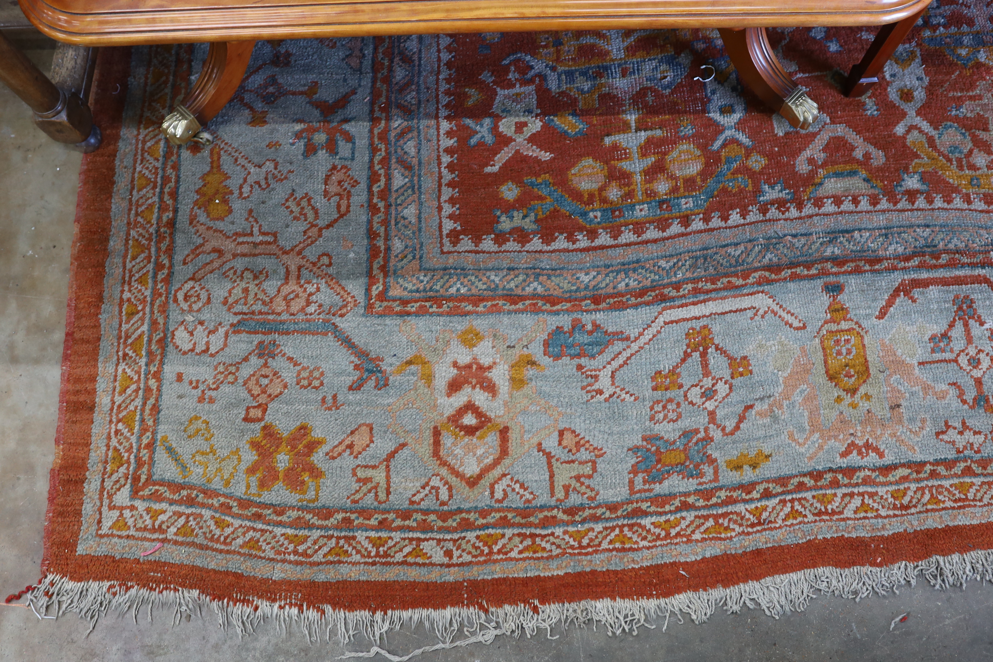 An Afghan red ground carpet, 395 x 310cm
